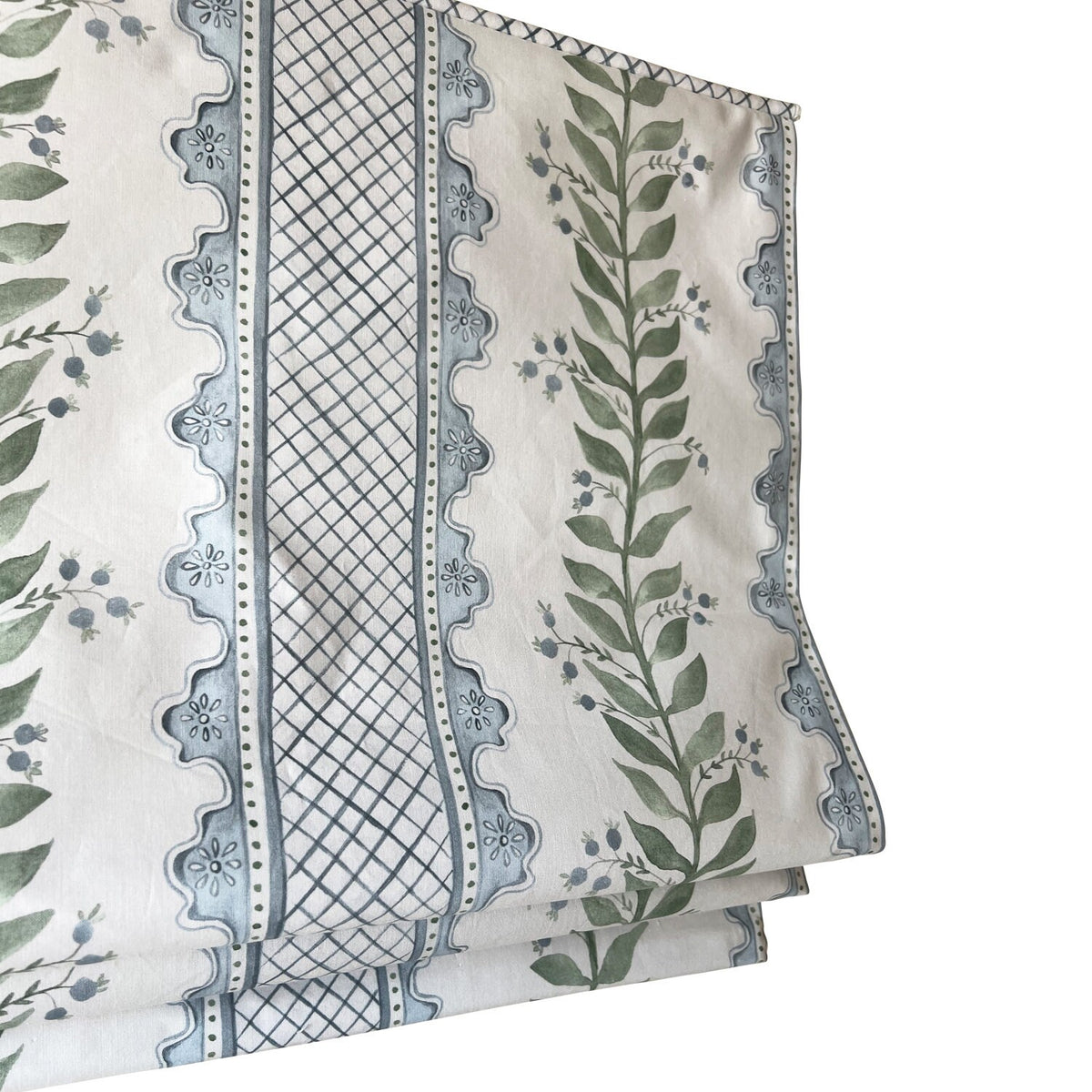 Celia Quiet Blue on Cream fabric folded in thirds, showing the blue and green floral repeat