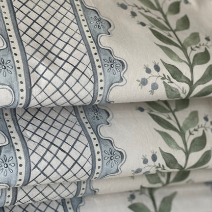 Close-up of the Celia lattice pattern in blue and green on a cream ground
