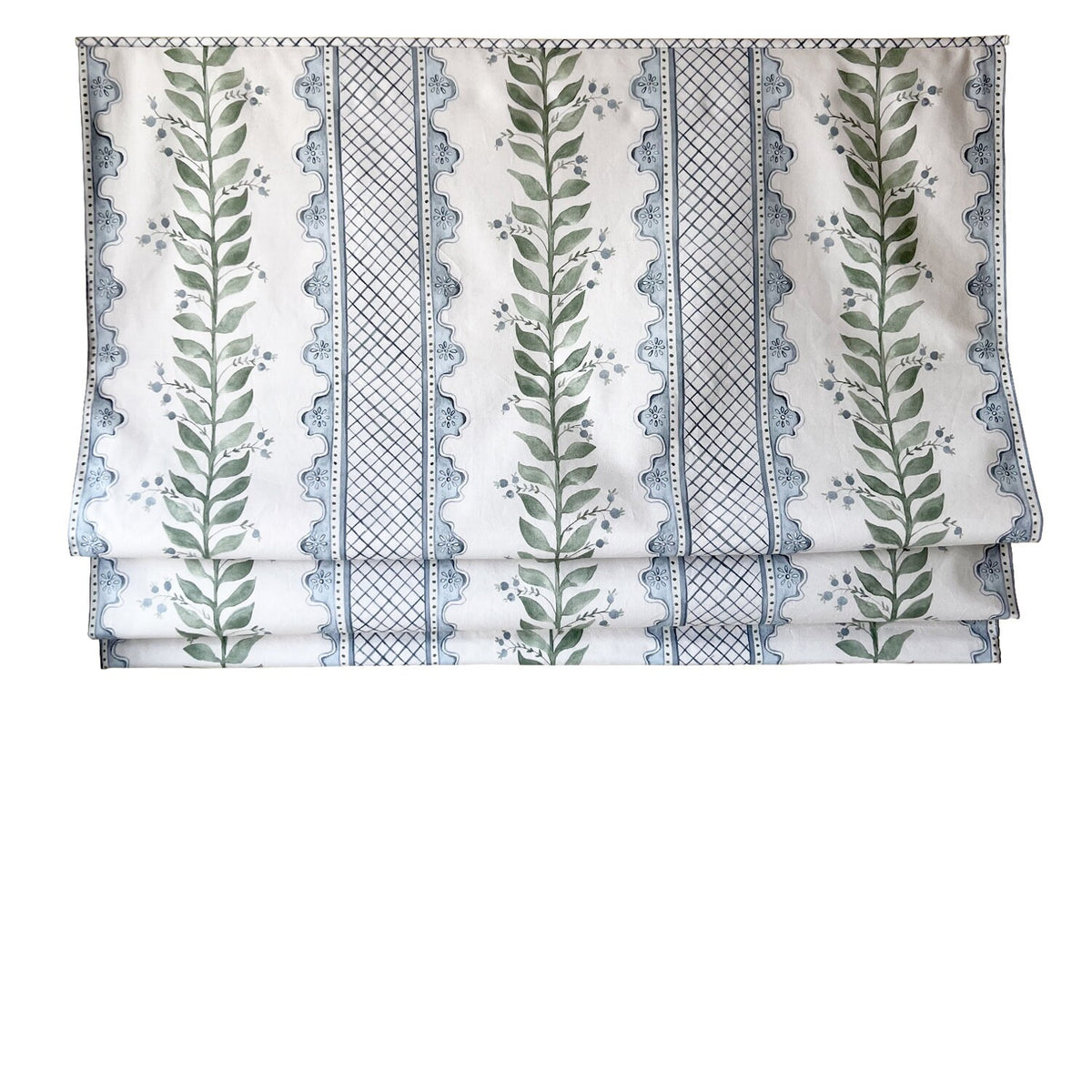 Soft folds of the Celia Roman shade showing the repeating blue trellis and leaf pattern