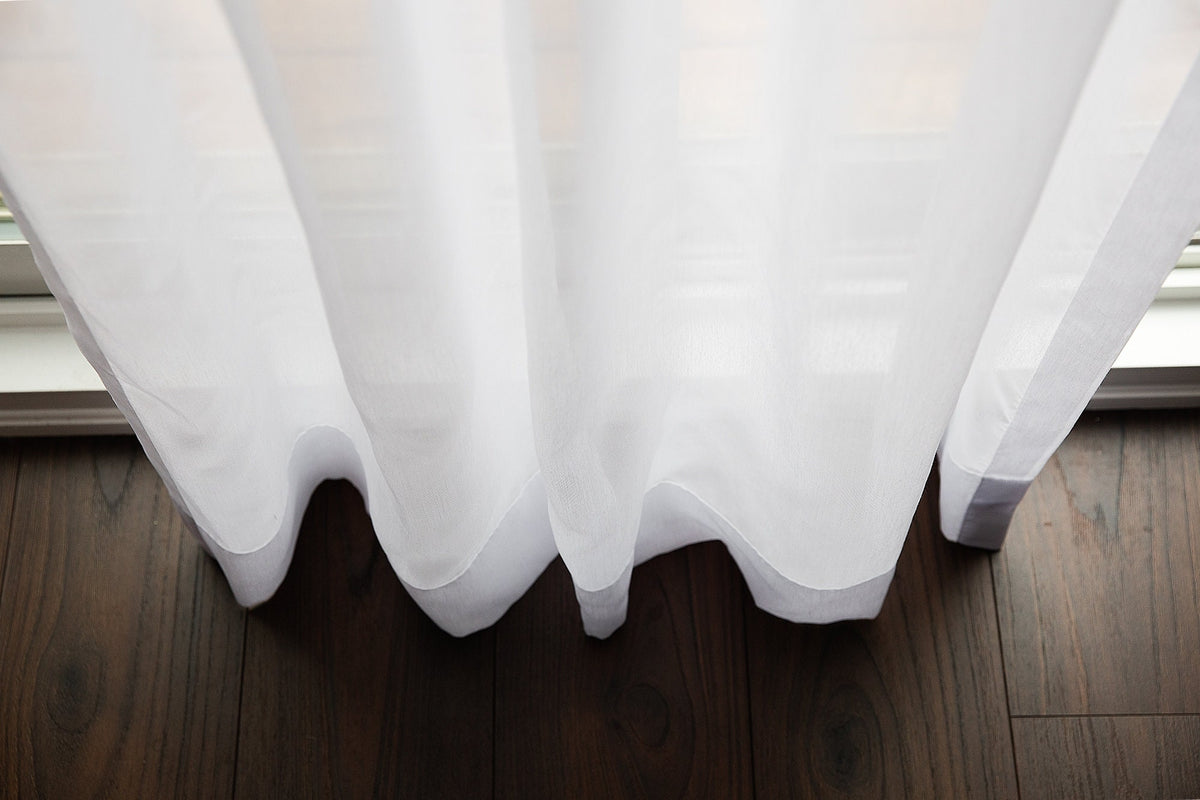 Full-length Dallas sheer panels in a room with dark wood flooring