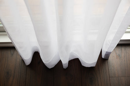 Full-length Dallas sheer panels in a room with dark wood flooring