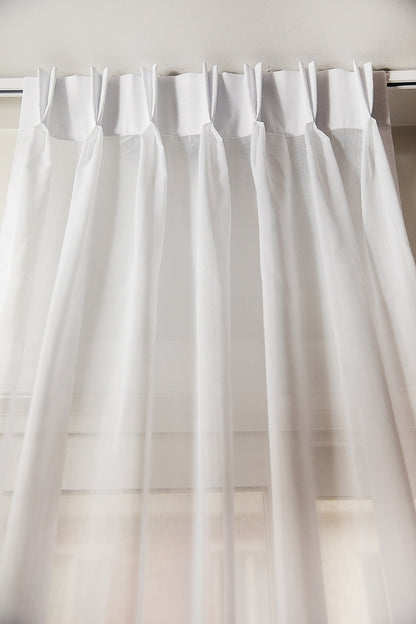 Dallas sheer double pleat drapery panel in white, hung on a track