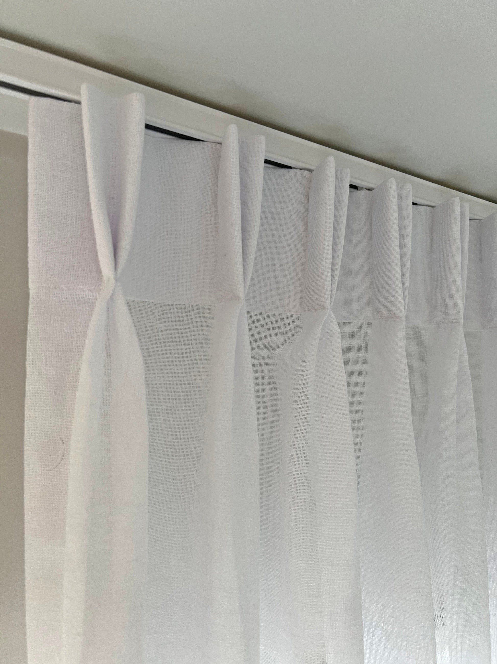 One-way draw traverse rod installed with pinch pleat drapery