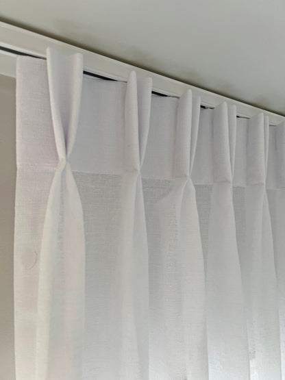 One-way draw traverse rod installed with pinch pleat drapery