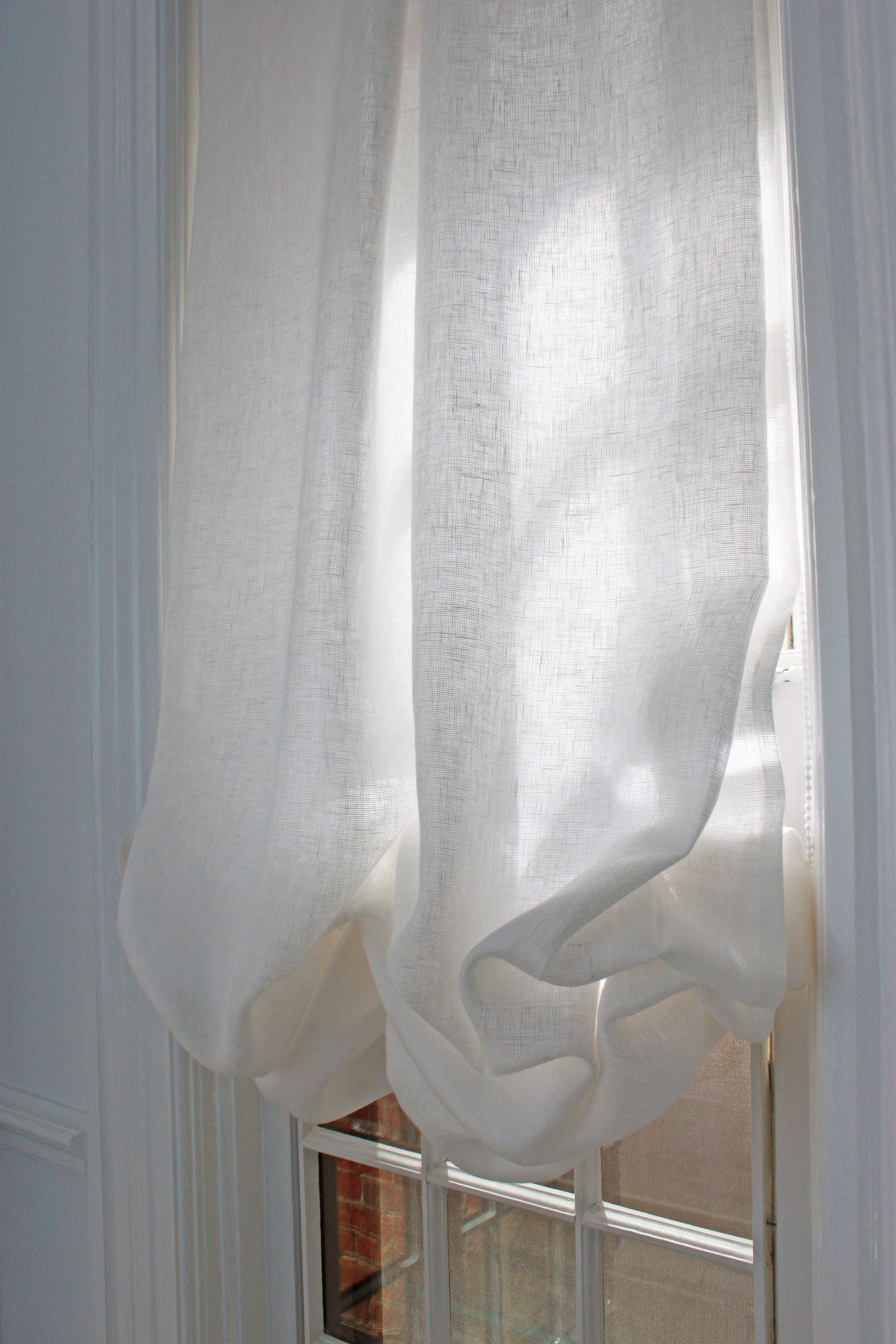 Daylight glowing through opaque Tuscany White linen, fold close-up — LOGANOVA