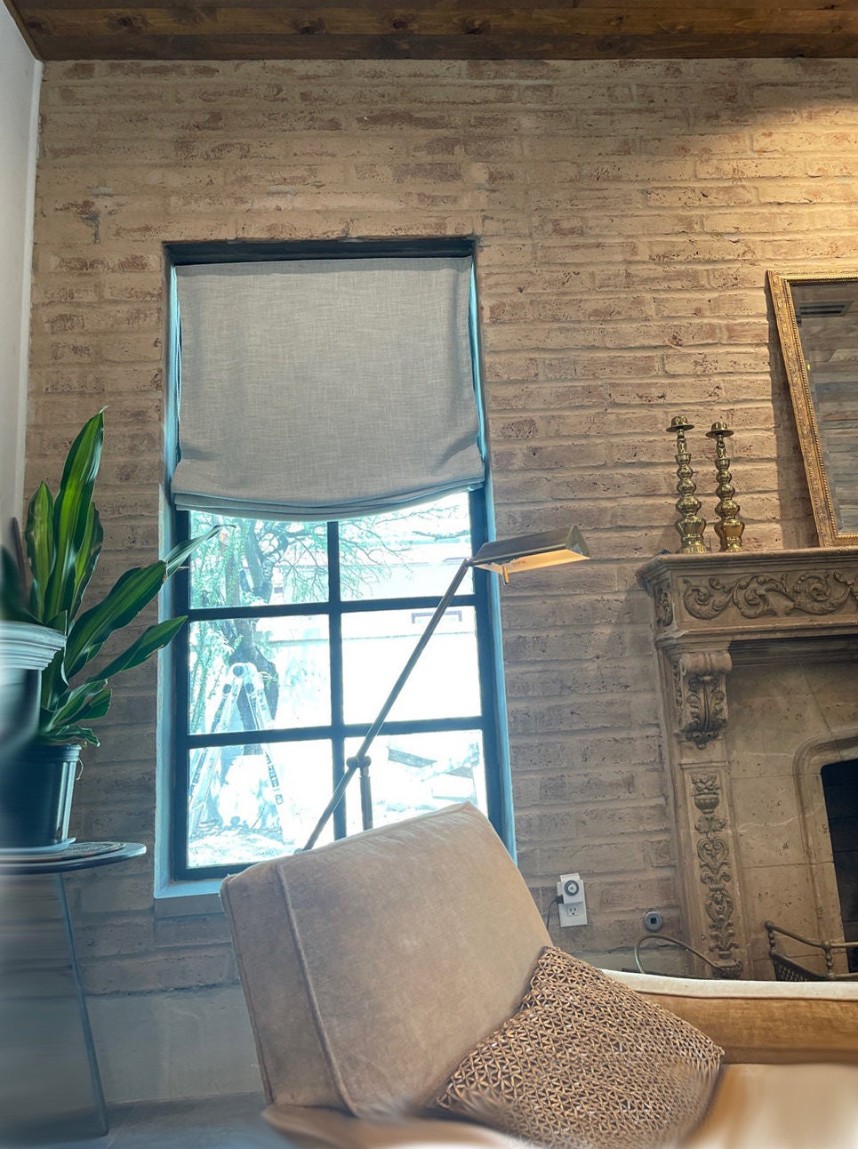 Custom Roman shade with chain mechanism in a living room