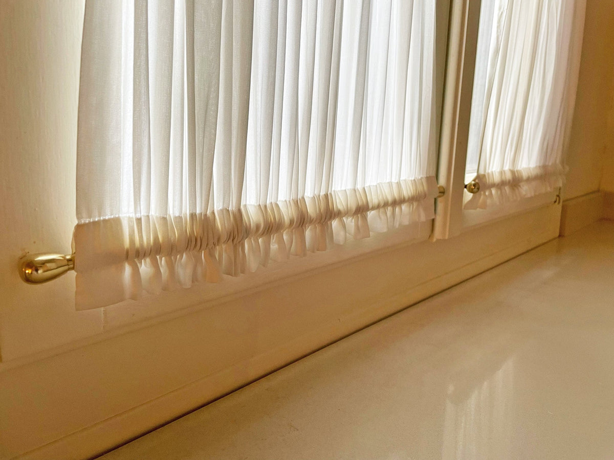 Cafe curtain on a swing-open window