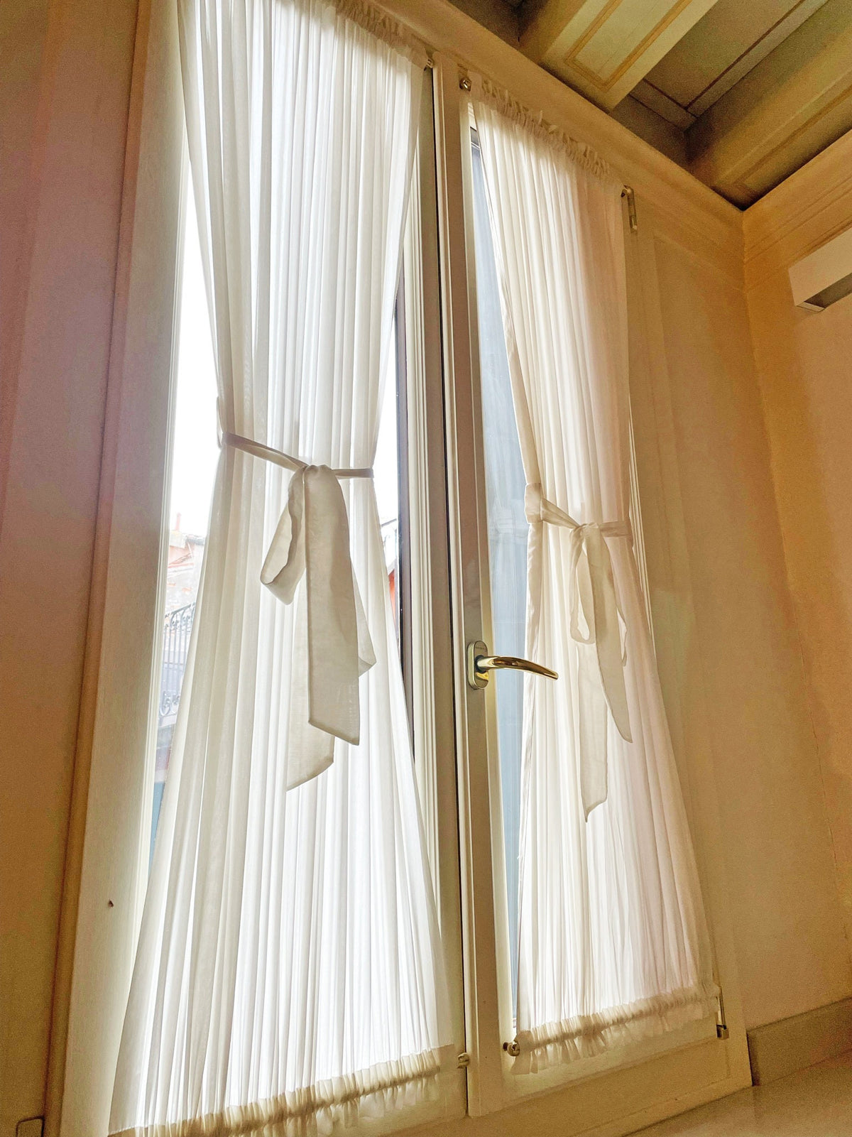 Kidman sheer cafe curtains with top and bottom pockets on a window
