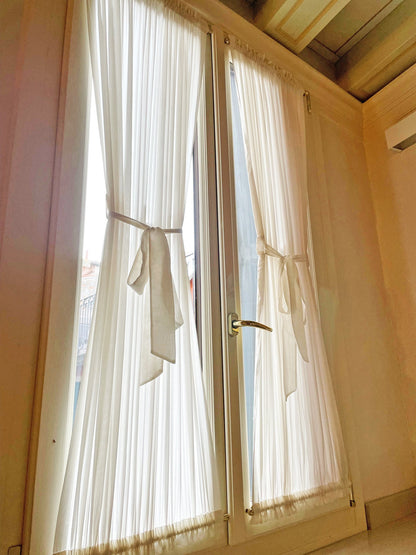Kidman sheer cafe curtains with top and bottom pockets on a window