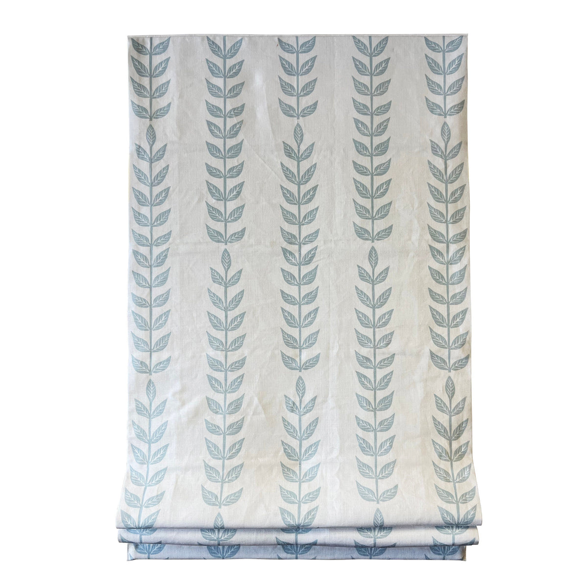 Fabric detail — white vine pattern printed on soft blue Belgian linen
