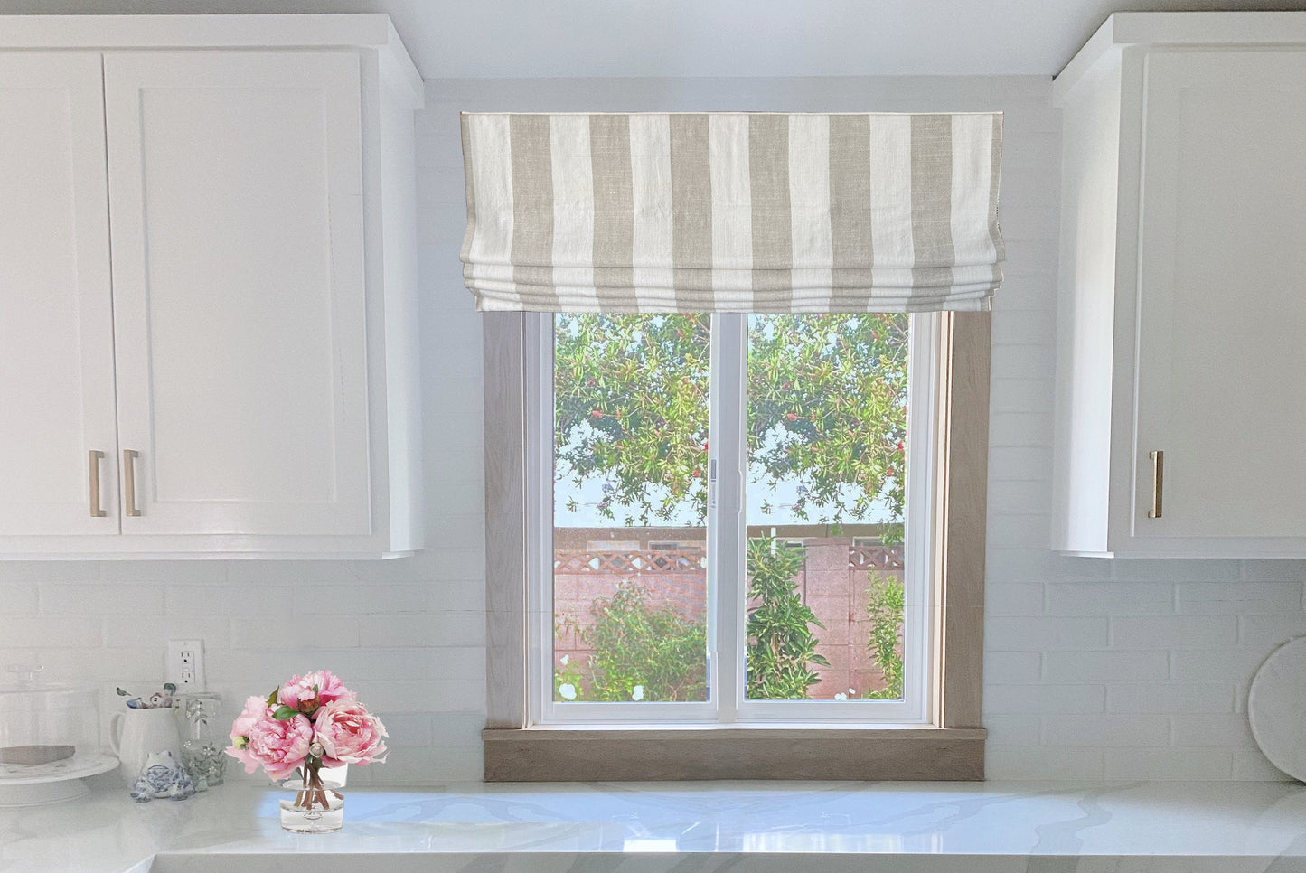 Copacabana relaxed linen Roman shade in a styled window, handmade in Toronto