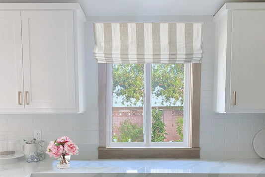 Copacabana relaxed linen Roman shade in a styled window, handmade in Toronto