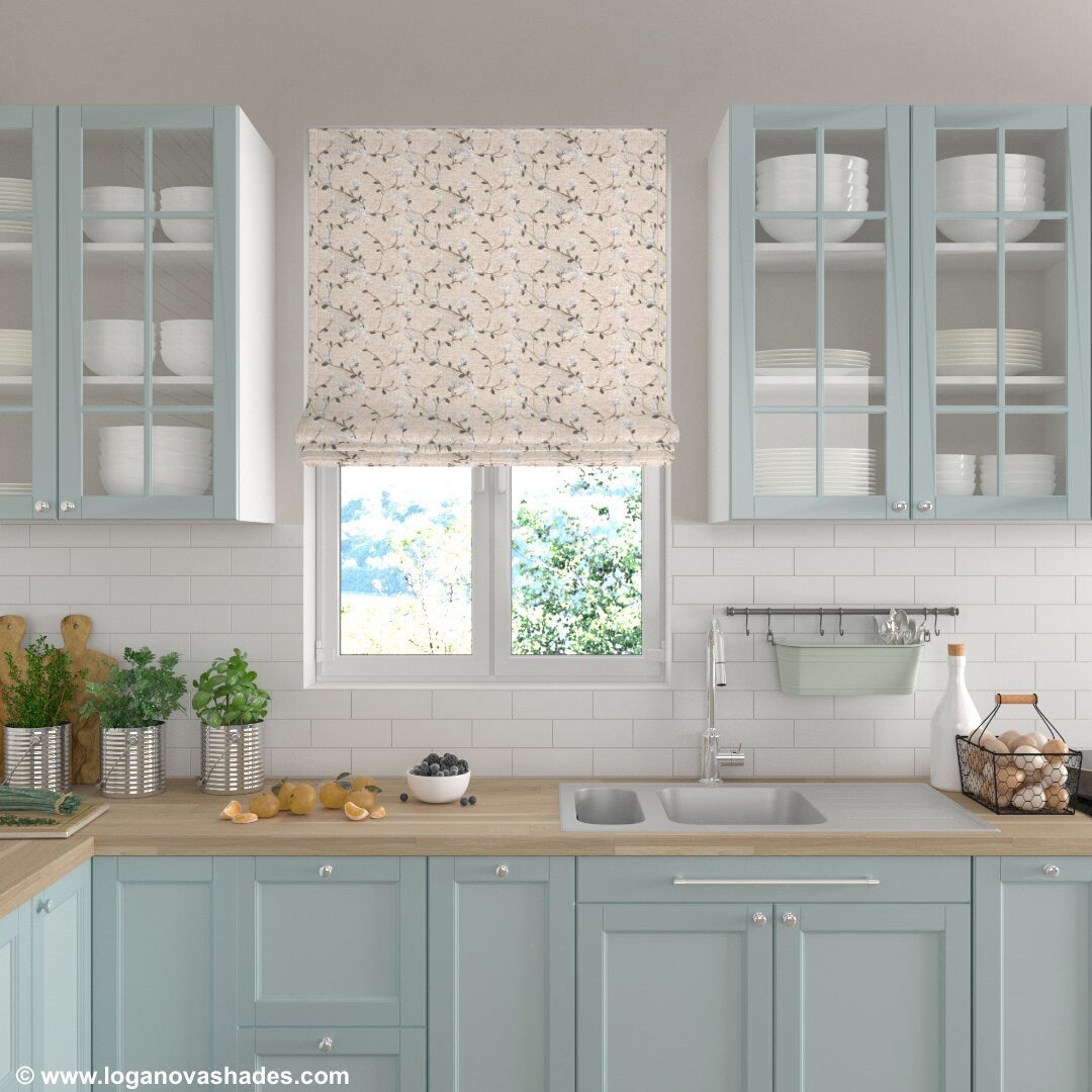 Beatrix floral Roman shade in a light blue kitchen with white subway tile and wood countertops