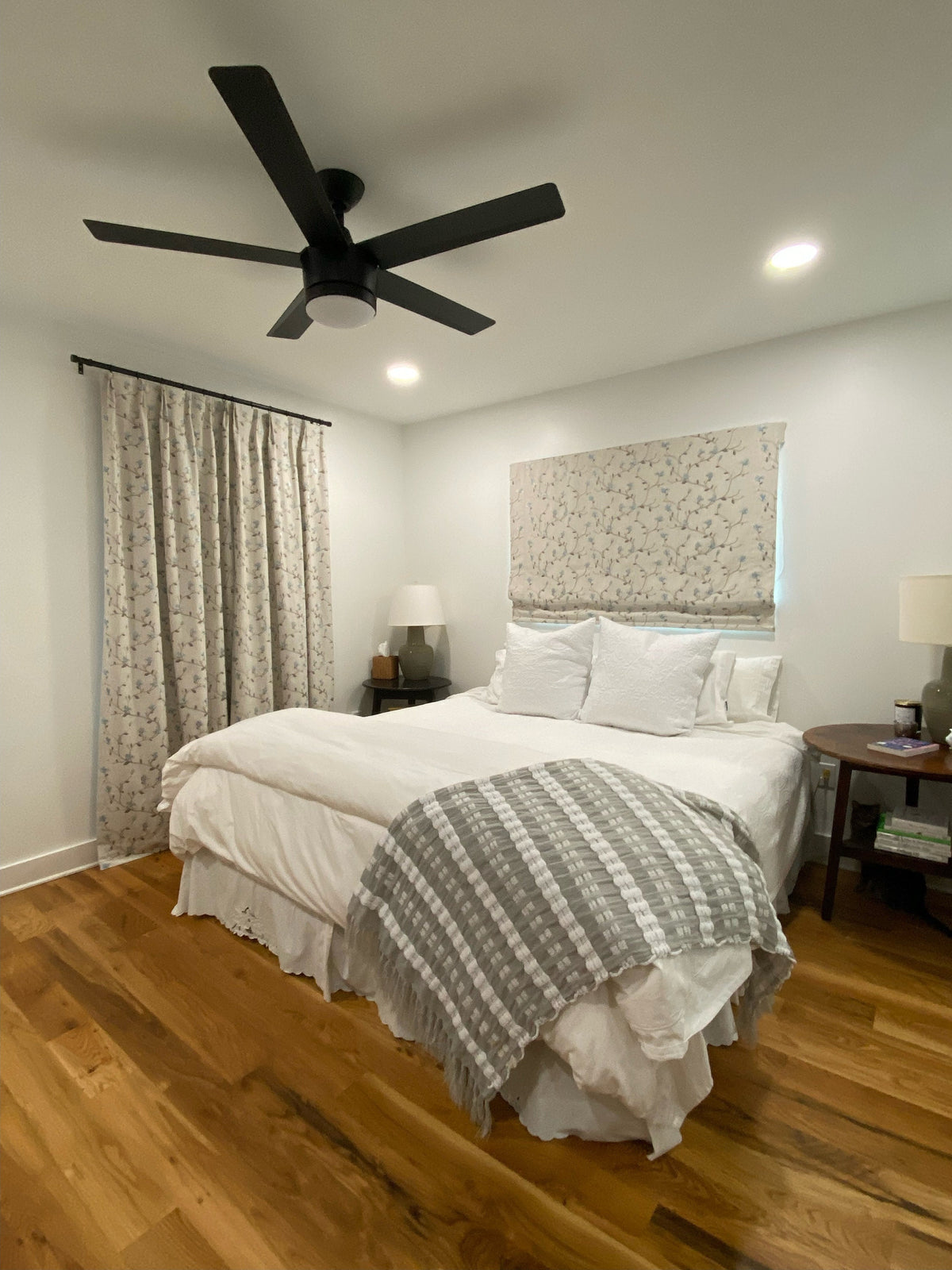 Bedroom styled with Beatrix floral Roman shade and striped bedding