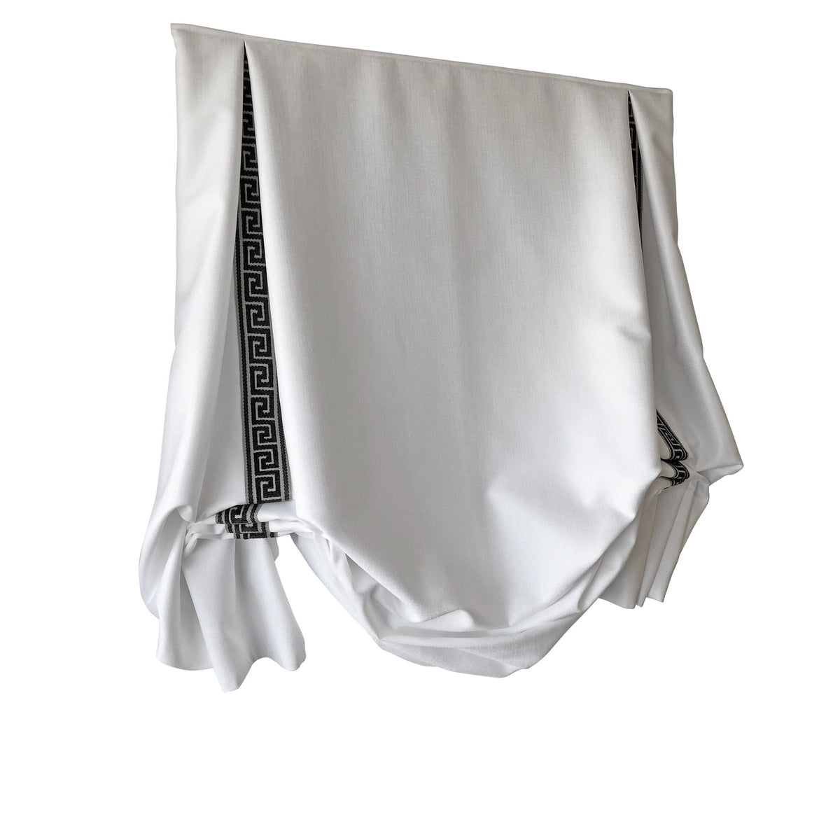 White London tulip Roman shade with black and gold Greek key trim in a window