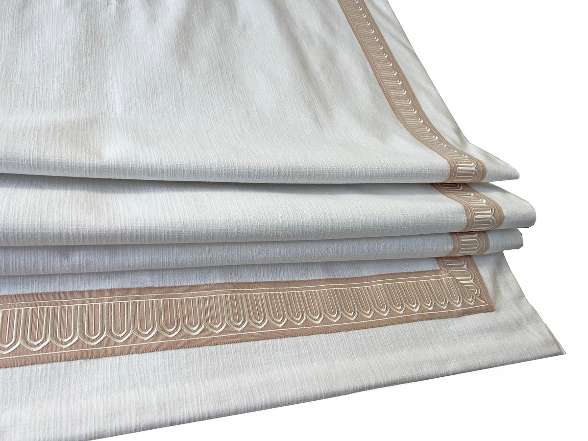 Relaxed Roman shade soft bottom curve in a sunlit window