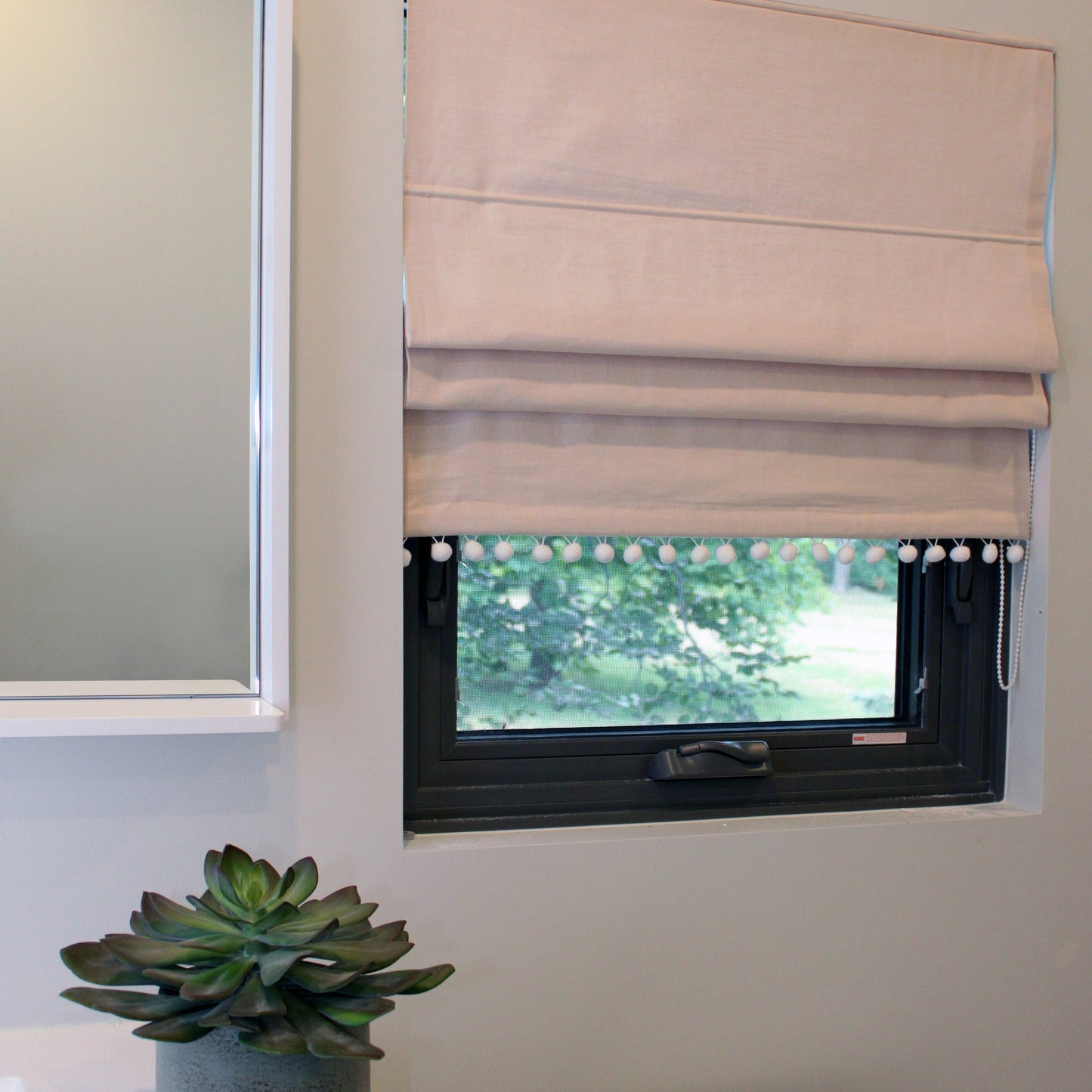 Pom pom trim Roman shade in a kids room window, handmade in Toronto