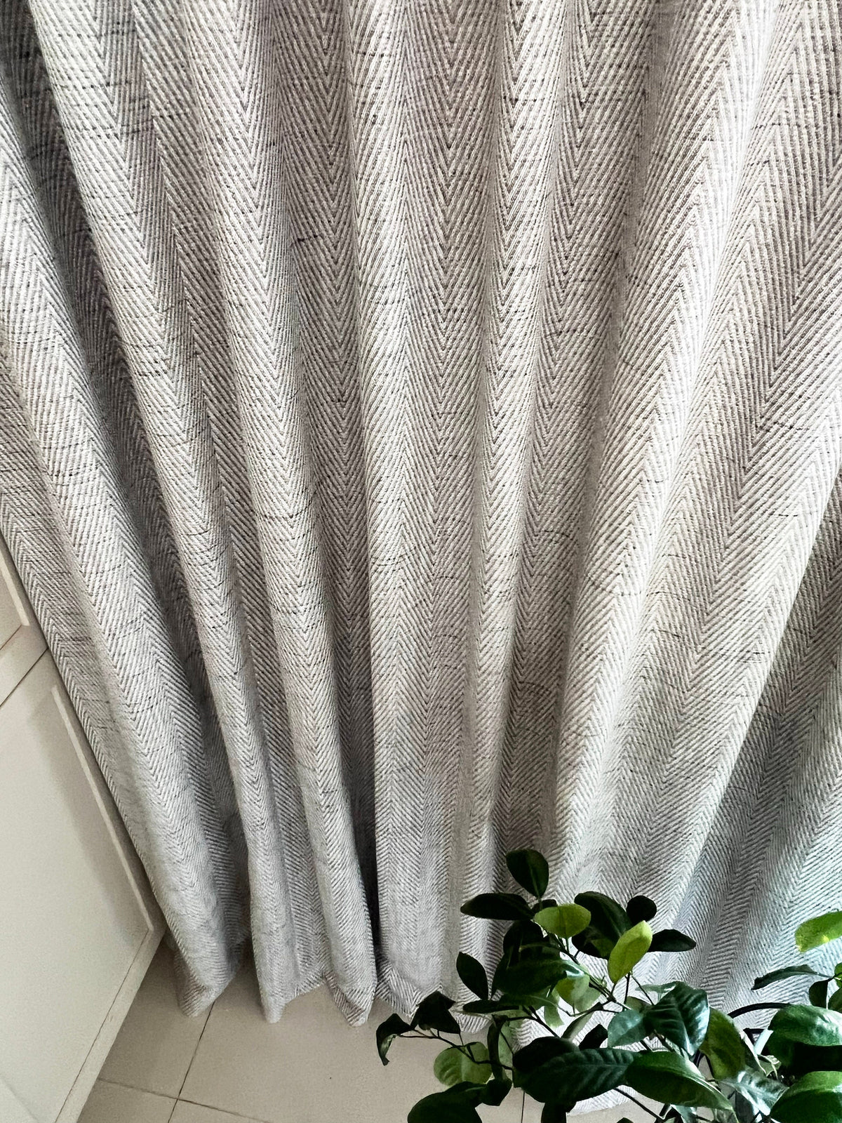 Corrie drapery panels pulled aside over a tiled floor