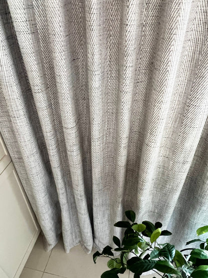 Corrie drapery panels pulled aside over a tiled floor
