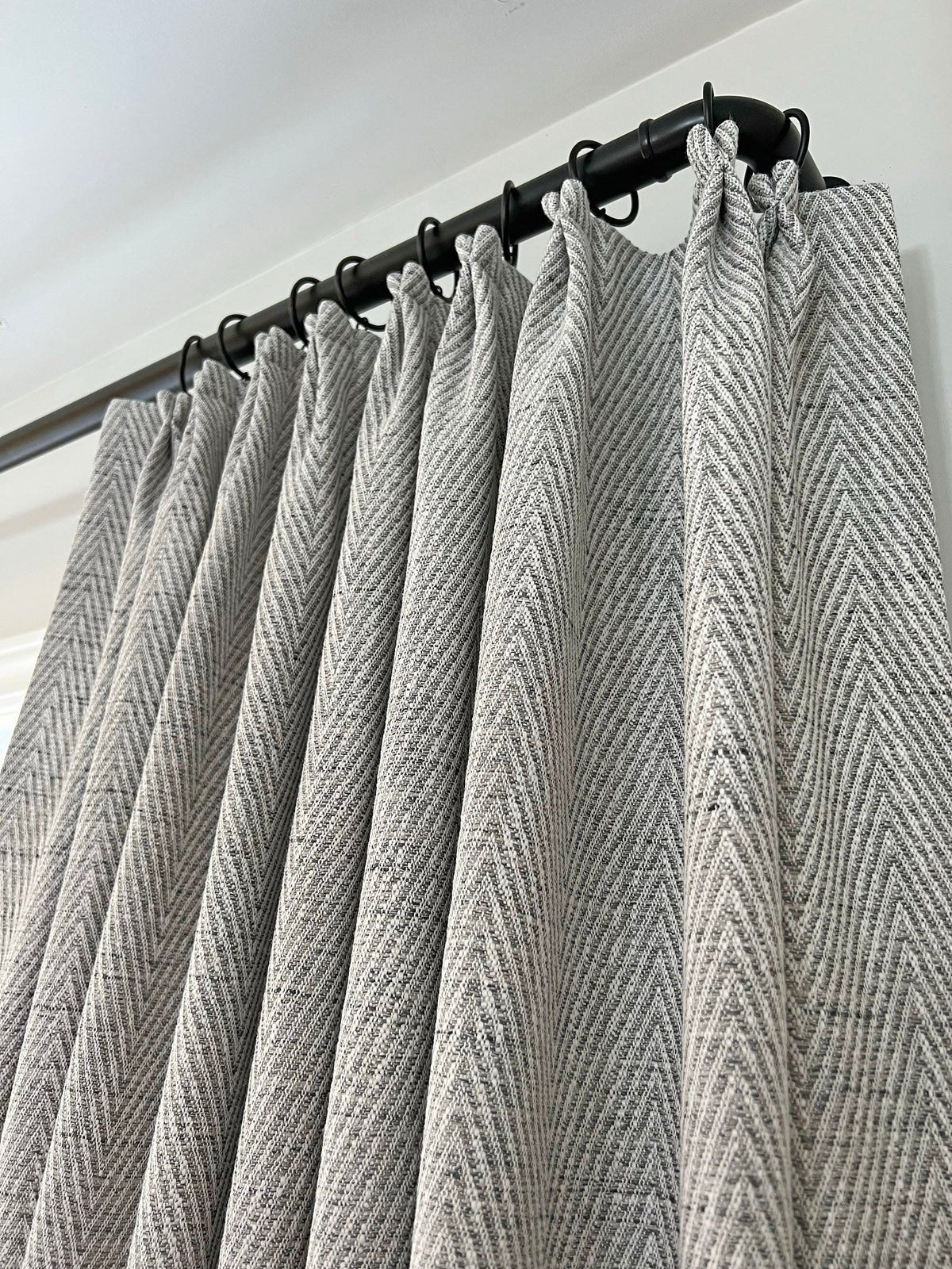 Corrie French pleat curtains on a black metal rod