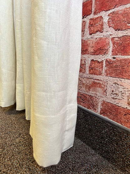 Linen s-fold curtain panel stacked back beside the window frame