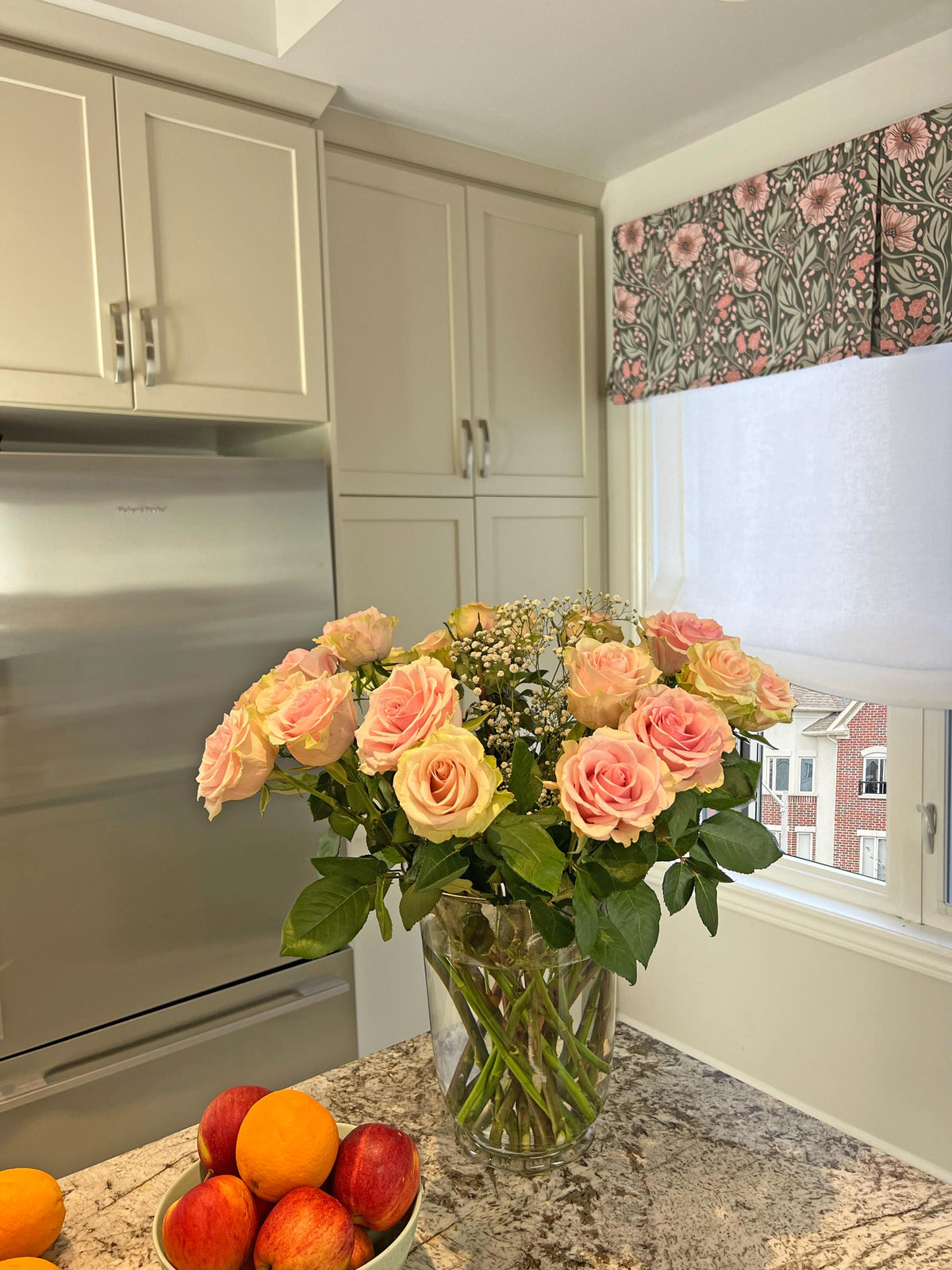 Arts & Crafts floral pleated valance in dark green and pink, styled with roses on a counter