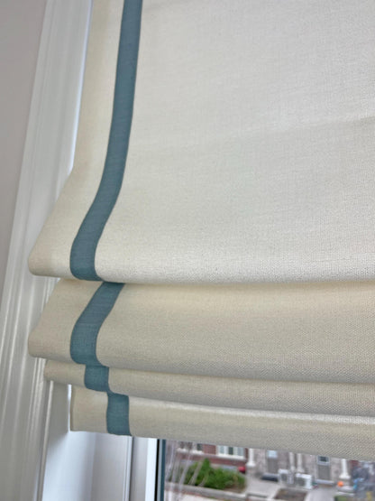 Soft smile hem of the relaxed Roman shade with the contrast border running along both sides