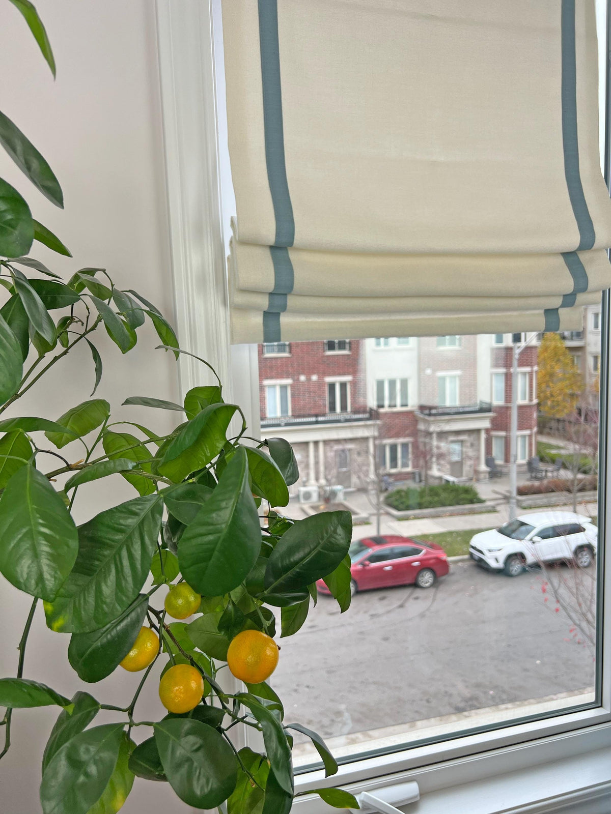 Relaxed Roman shade in faux linen with a 1 inch contrast border inset 2 inches, chain mechanism, custom made in Toronto