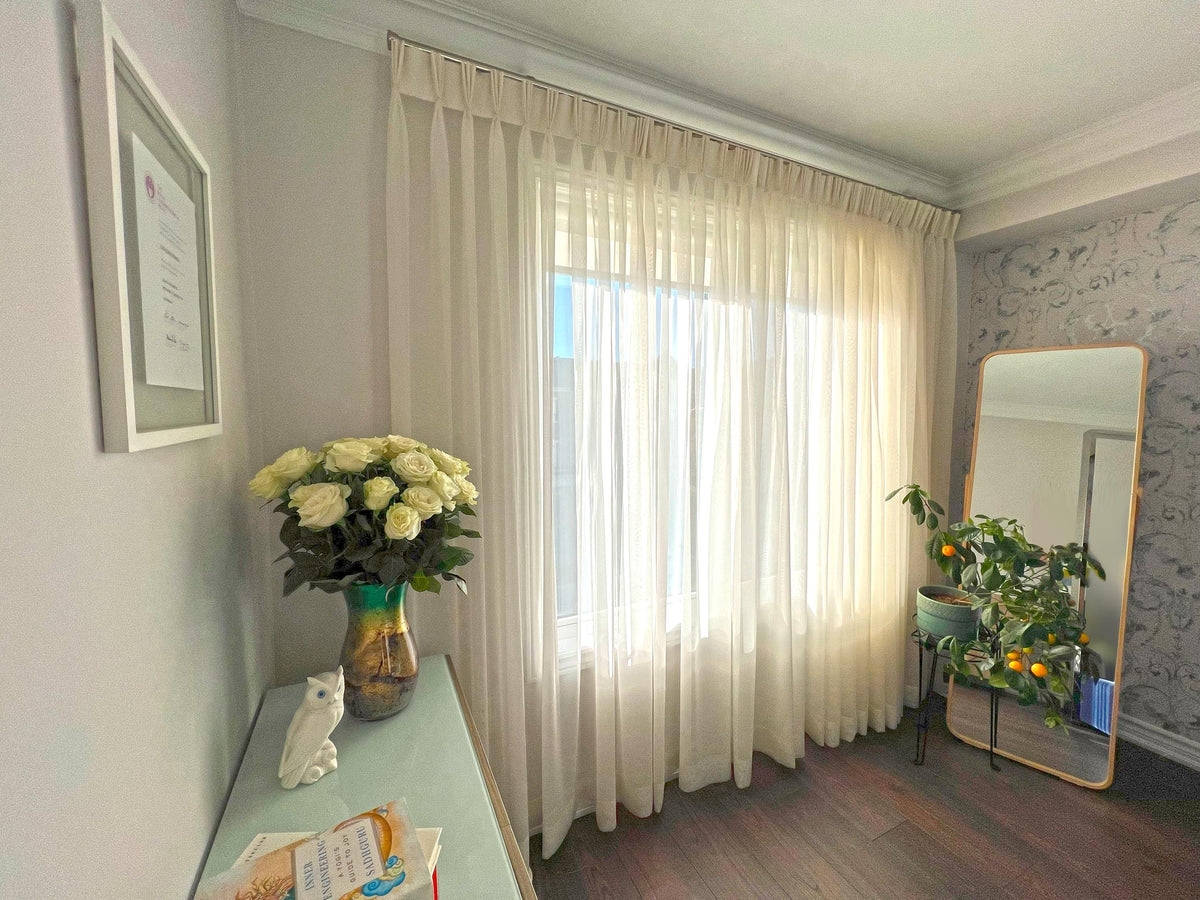 Empire voile triple pleat sheers styled with white roses in a green vase — LOGANOVA