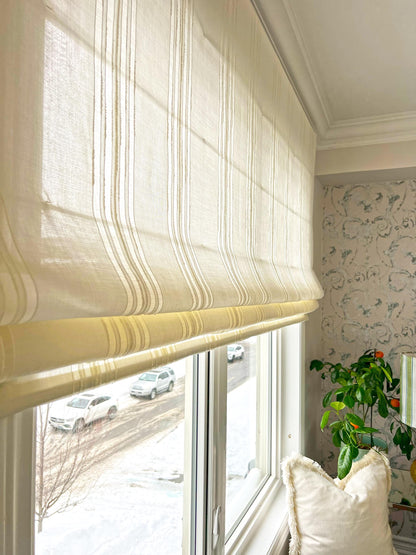 Spinello flat Roman shade raised into crisp flat folds — striped face