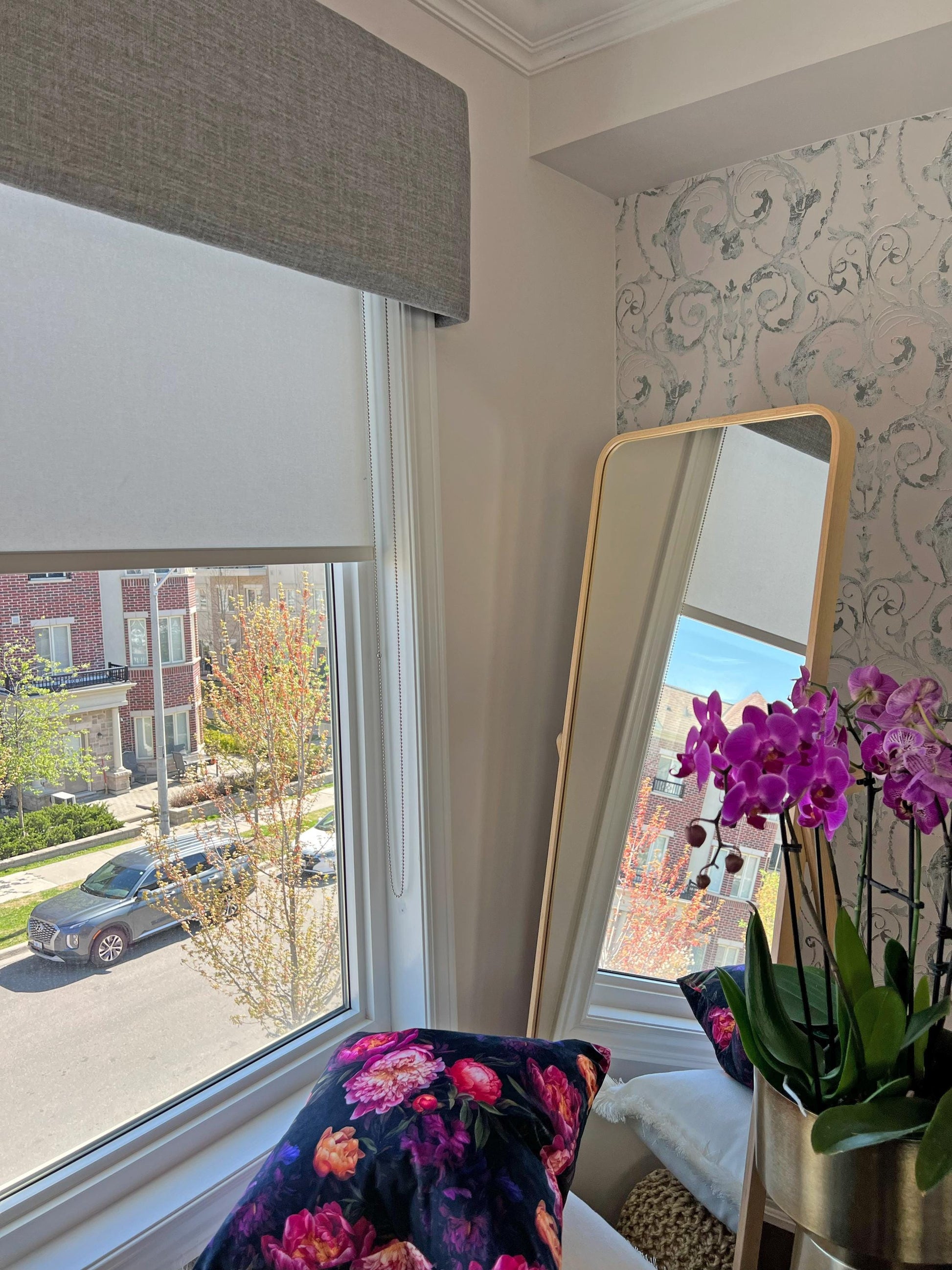 Grey Toronto upholstered cornice over a roller shade in a bay window — LOGANOVA
