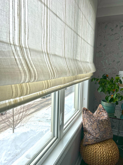 Spinello flat Roman shade partially raised showing flat folds — beige stripe