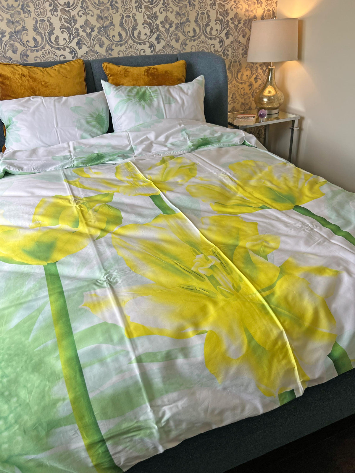 Floral bedding styled with plain sheets in a bedroom