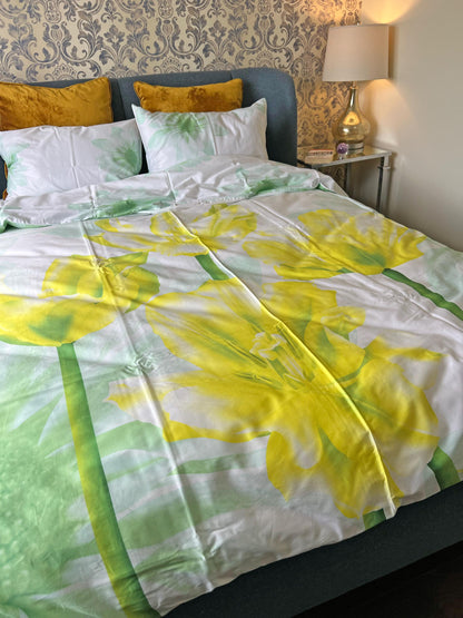 Floral bedding styled with plain sheets in a bedroom