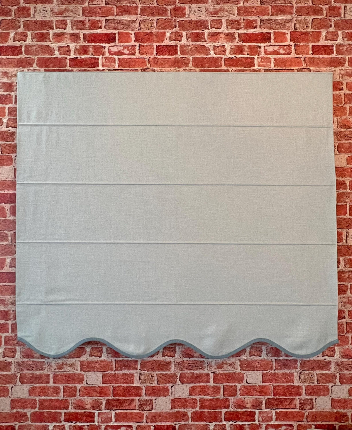 Regatta linen blend Roman shade styled in a calm neutral living room setting