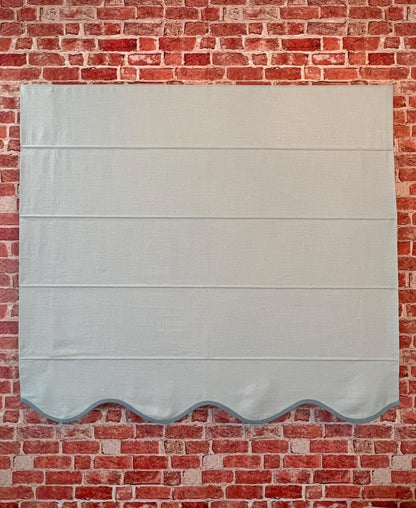 Regatta linen blend Roman shade styled in a calm neutral living room setting