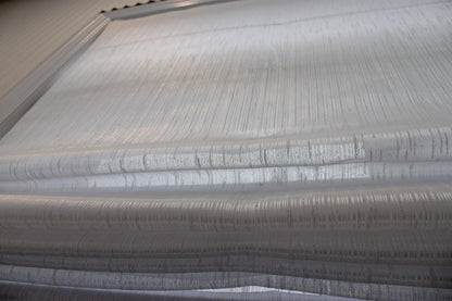 Side chain control with child-safety tension device on the Lugano Roman shade
