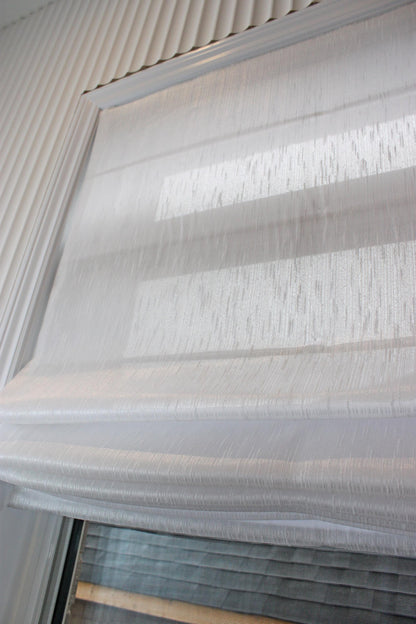 Lugano faux linen relaxed Roman shade in Lugano White, soft smile along the bottom edge