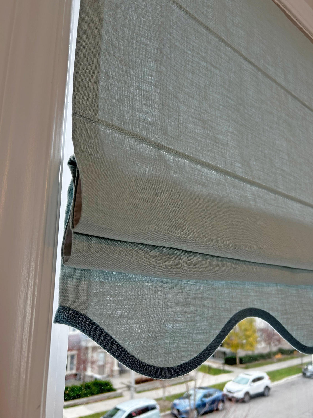 Fold detail showing the crisp flat folds of the raised Roman shade
