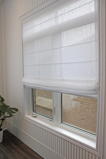 Lugano relaxed Roman shade raised, showing the gentle curve of the bottom edge