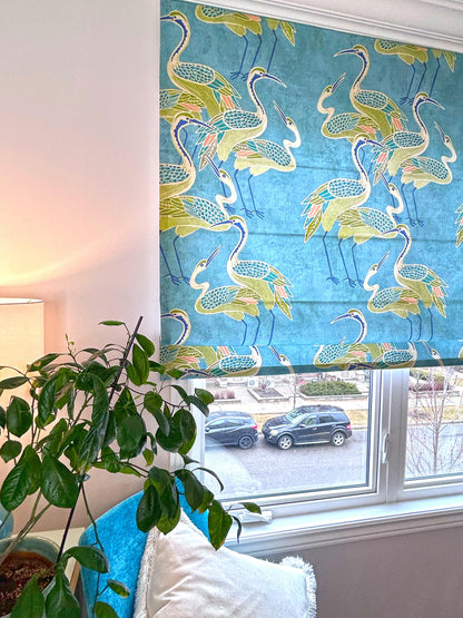 Deco Cranes pool-blue crane-print Roman shade, fully extended — front view