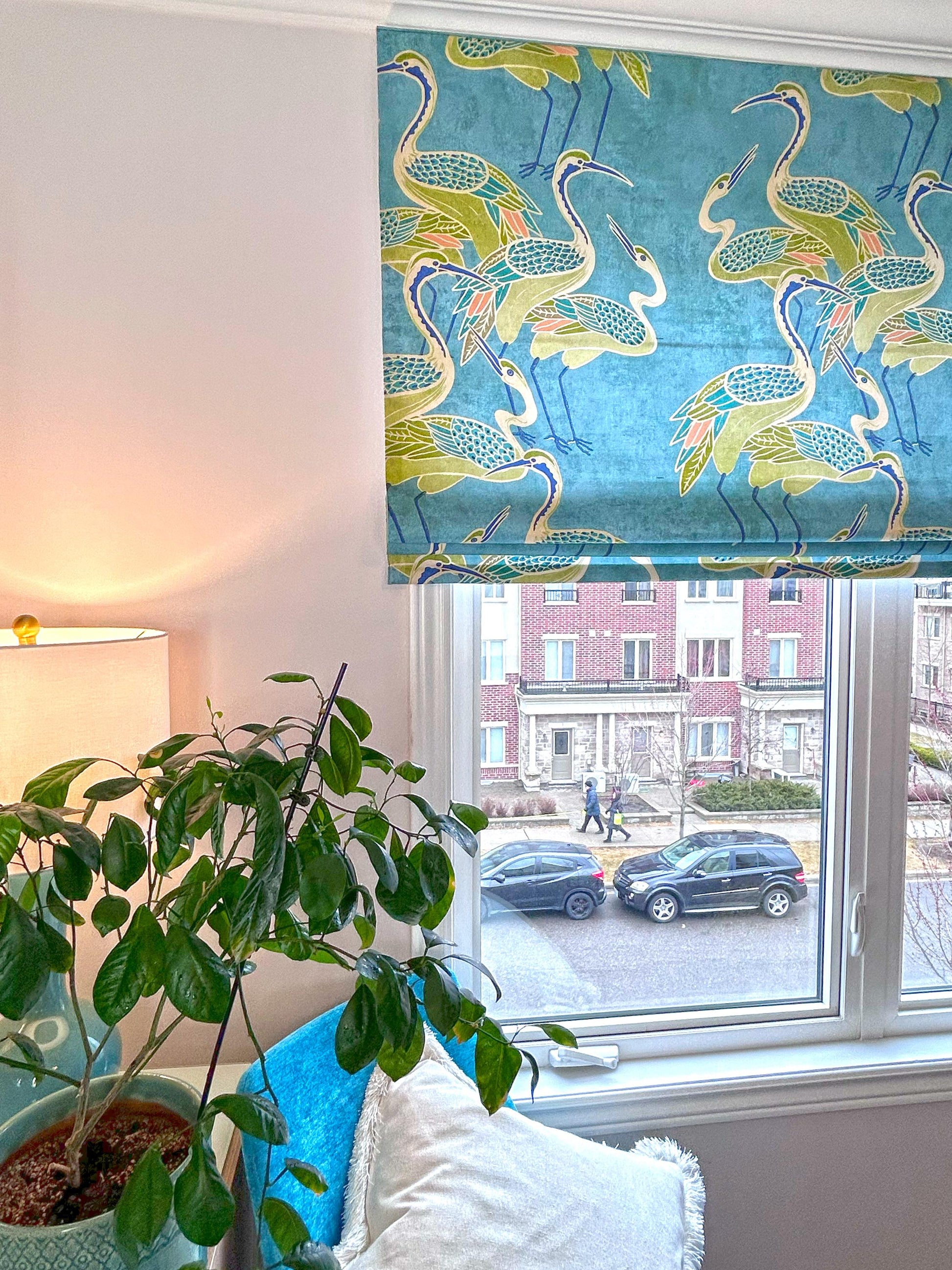 Deco Cranes relaxed Roman shade in pool blue at a bright window — custom made