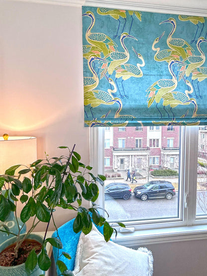 Deco Cranes relaxed Roman shade in pool blue at a bright window — custom made