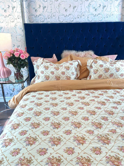 Tessa bedding set layered with coordinating pillows