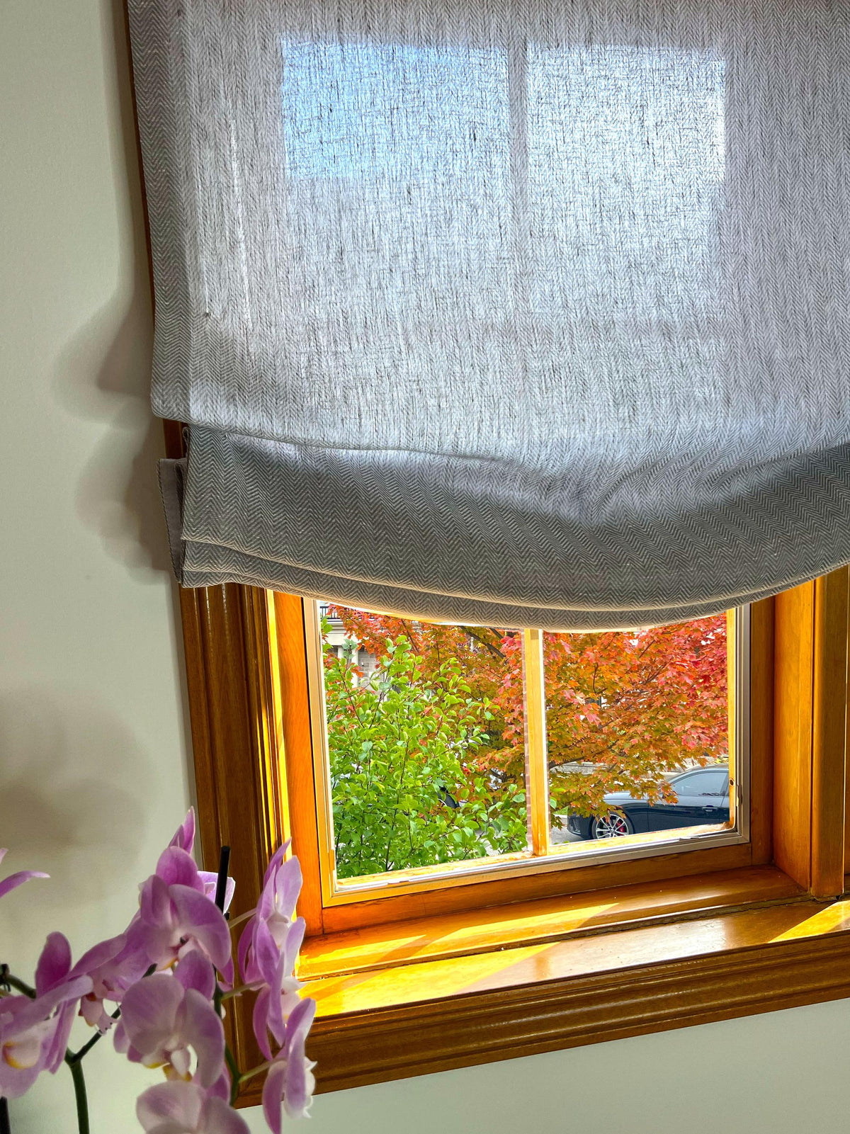 Rainfall sheer European relaxed Roman shade hanging in a window, custom made to order