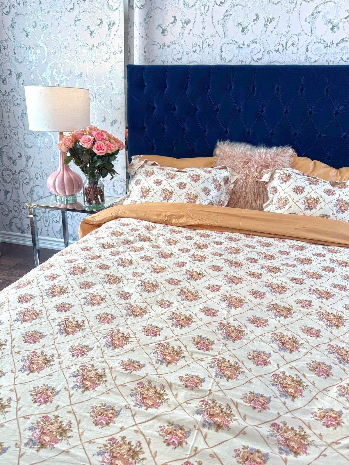 Tessa floral faux silk bedding set styled on a made bed