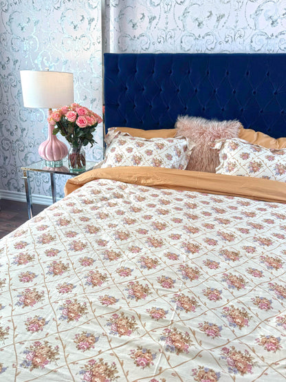 Tessa floral faux silk bedding set styled on a made bed