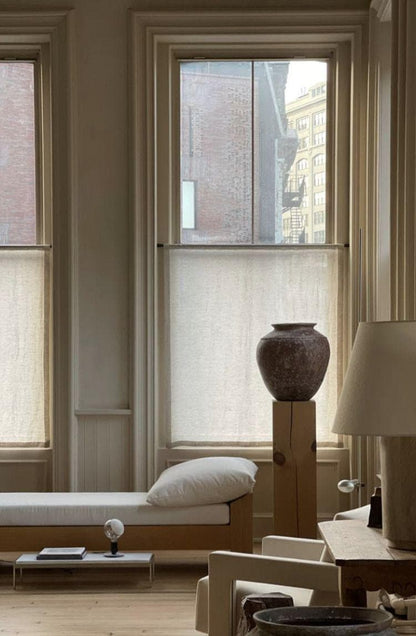 Bright interior with large windows, a daybed and sheer light-filtering curtains softening the daylight