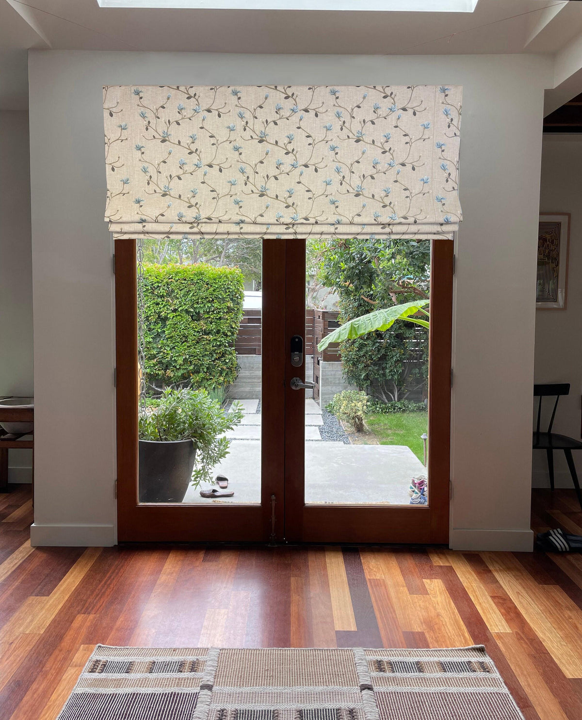 Beatrix Roman shade installed on French patio doors, daylight highlighting fabric texture