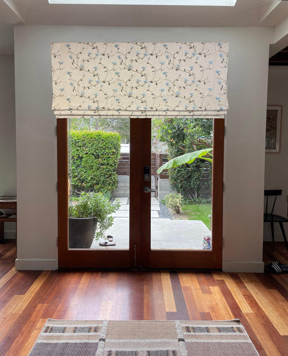 Beatrix Roman shade installed on French patio doors, daylight highlighting fabric texture